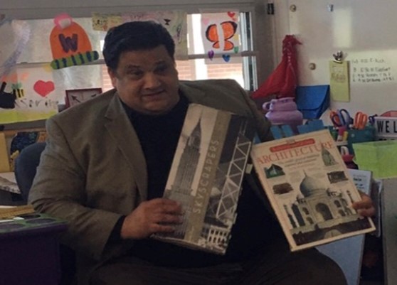 Arnoldo Cardona reads books to students. 