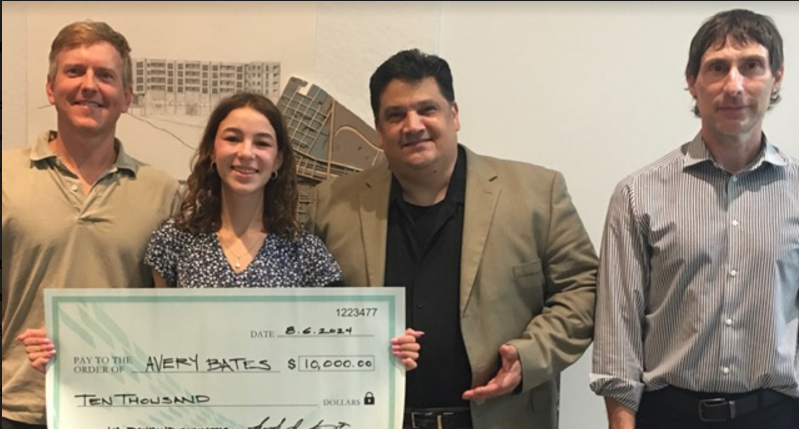 photo of 4 people with one holding an oversized check